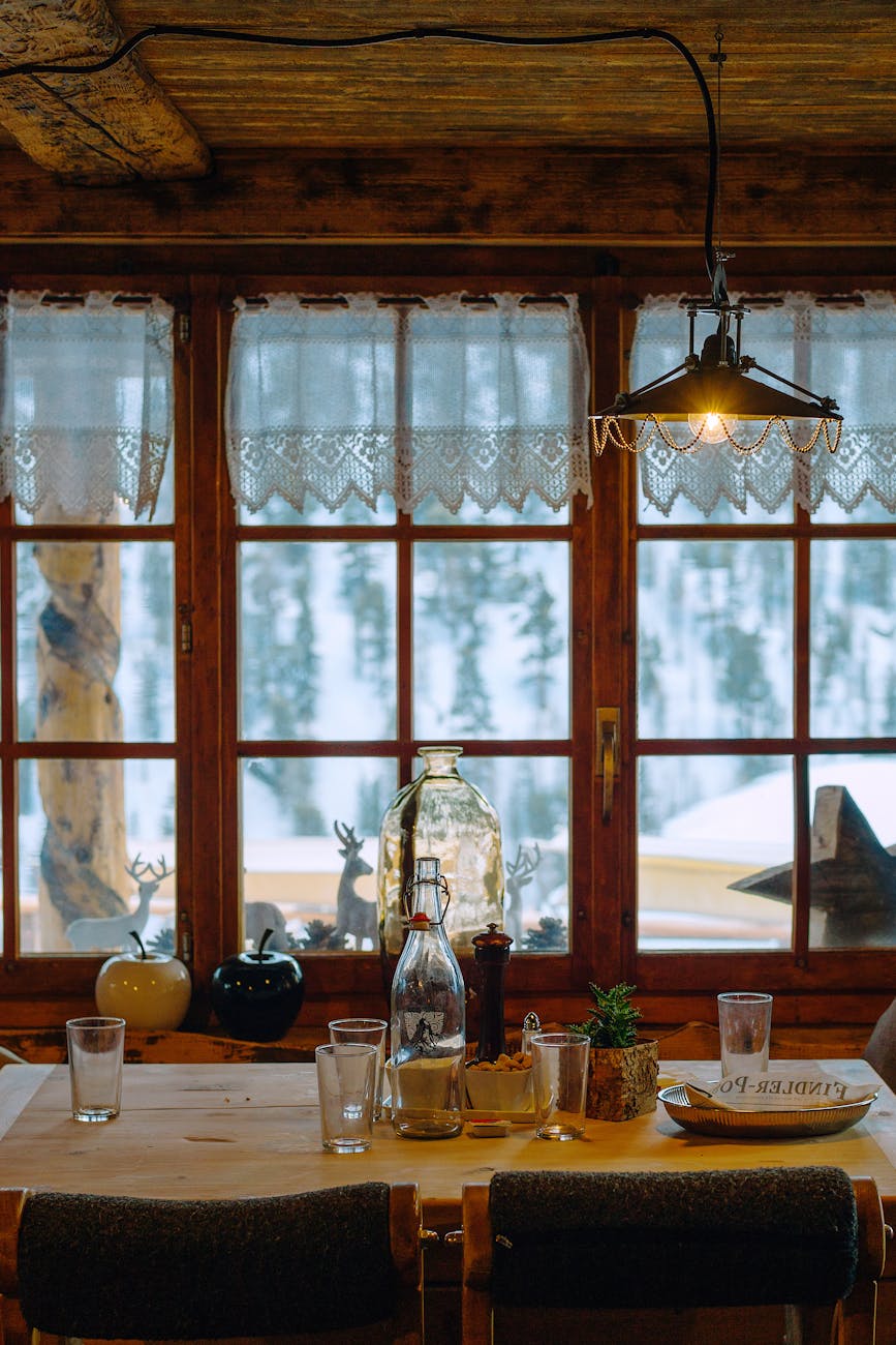 rustic house with glassware on table under lamp