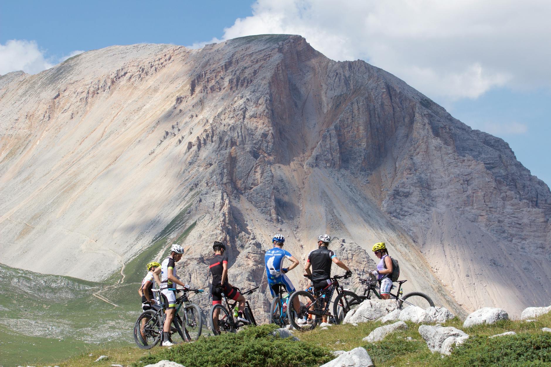 group of mountain bikers parked near the mountains